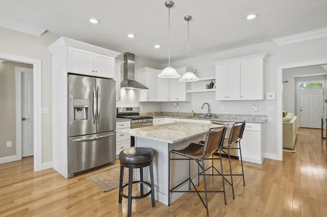 80 Edgemere Ave Unit 80, Northbridge, MA 01588 - kitchen with appliances with stainless steel finishes, wall chimney range hood, open shelves, a breakfast bar, and light wood-type flooring