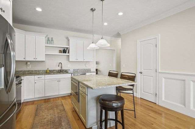 80 Edgemere Ave Unit 80, Northbridge, MA 01588 - kitchen featuring stainless steel appliances, a breakfast bar, white cabinets, open shelves, and crown molding