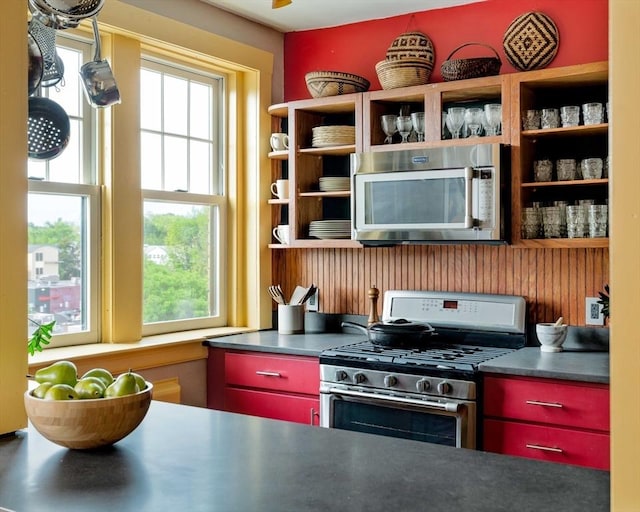 3 Newport Rd Unit 8, Cambridge, MA 02140 - kitchen featuring appliances with stainless steel finishes, open shelves, and red cabinets