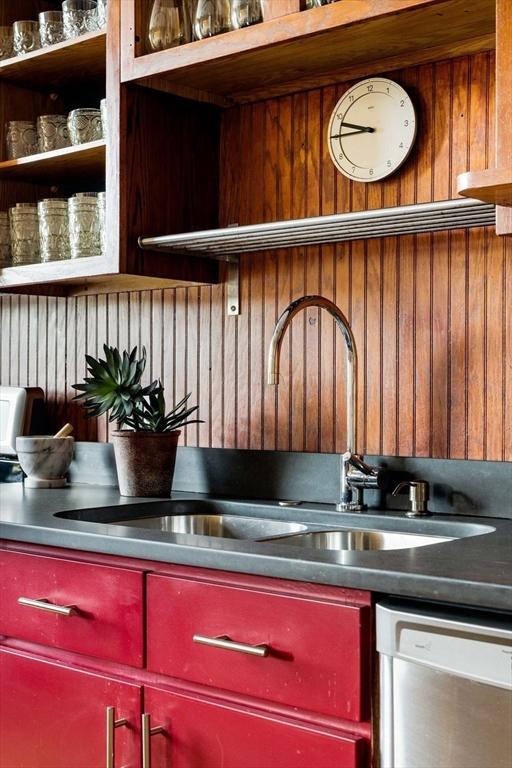 3 Newport Rd Unit 8, Cambridge, MA 02140 - kitchen with stainless steel dishwasher, red cabinetry, wooden walls, and open shelves