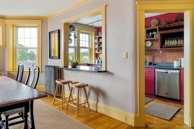 3 Newport Rd Unit 8, Cambridge, MA 02140 - dining area with light wood-style floors, radiator heating unit, and crown molding
