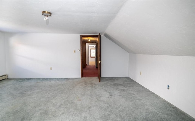 additional living space with carpet flooring and vaulted ceiling