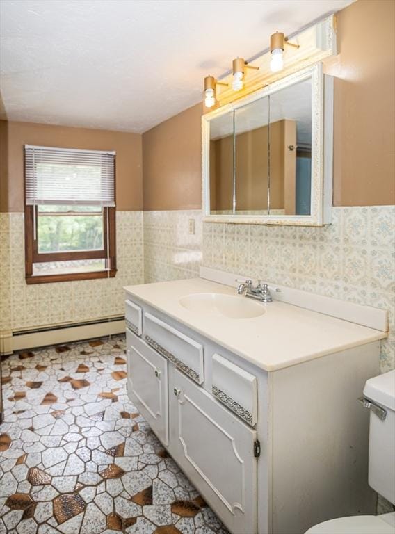 bathroom featuring vanity, a baseboard heating unit, tile walls, and toilet