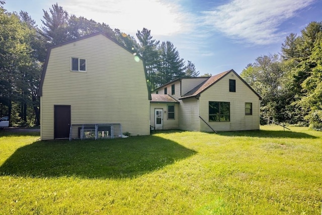 back of house with a lawn