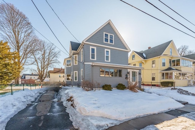 american foursquare style home featuring fence