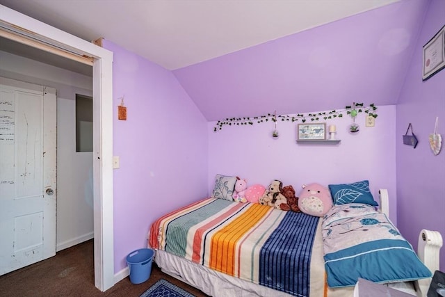 bedroom featuring dark carpet and lofted ceiling