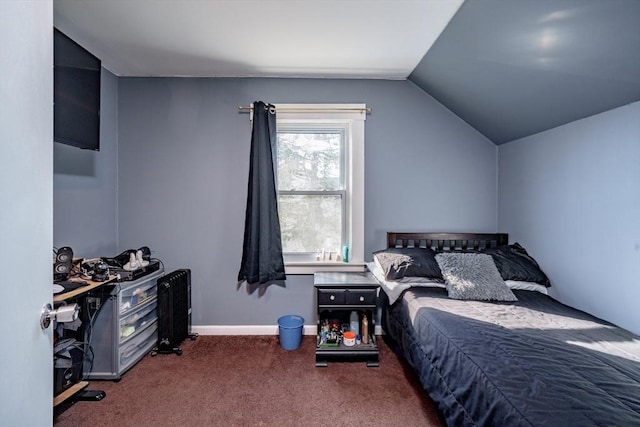 bedroom with lofted ceiling and dark colored carpet