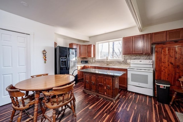 kitchen featuring dark wood-type flooring, white electric range oven, tasteful backsplash, black refrigerator with ice dispenser, and a kitchen island