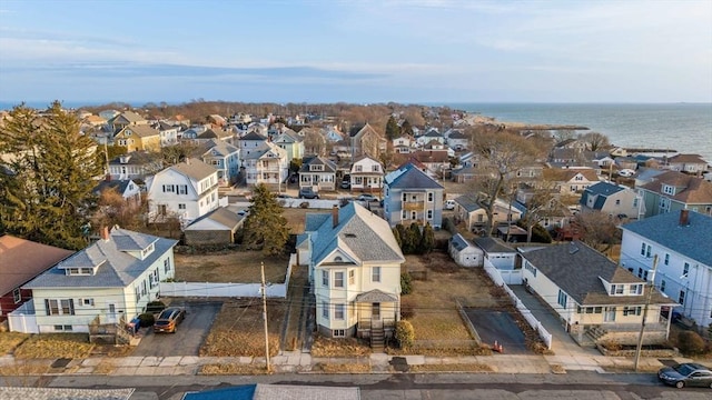 drone / aerial view featuring a residential view and a water view