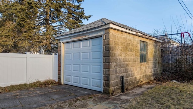 garage with fence