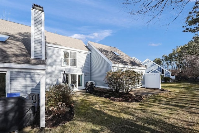 rear view of house with a lawn