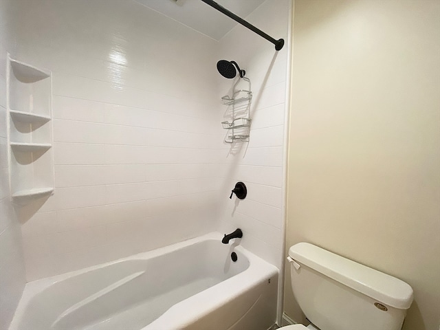 bathroom with toilet and tiled shower / bath combo