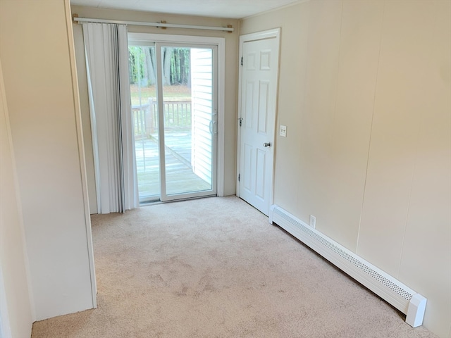 unfurnished room featuring baseboard heating and light colored carpet