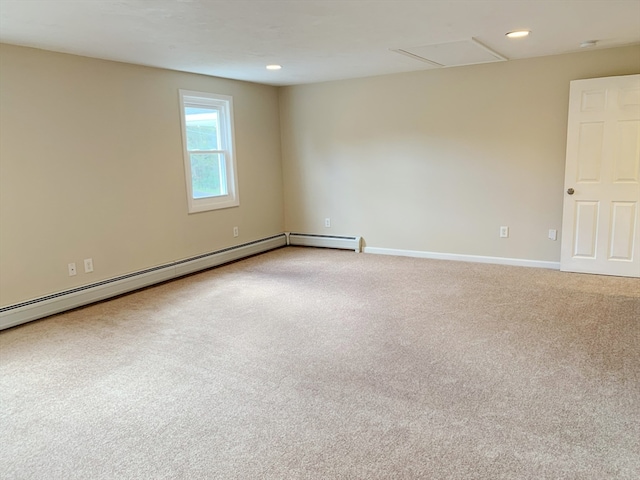 carpeted spare room with a baseboard radiator