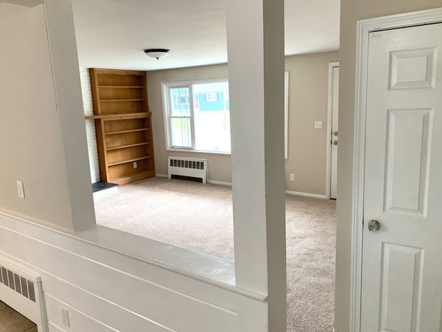 interior space featuring radiator heating unit and carpet