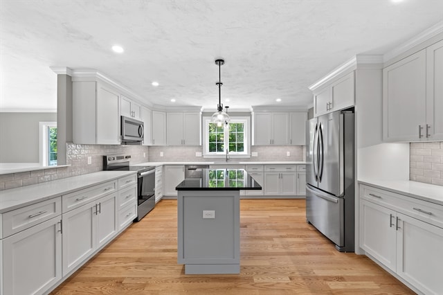 233 W Mountain St, Worcester, MA 01606 - kitchen with appliances with stainless steel finishes, a center island, decorative backsplash, recessed lighting, and a sink
