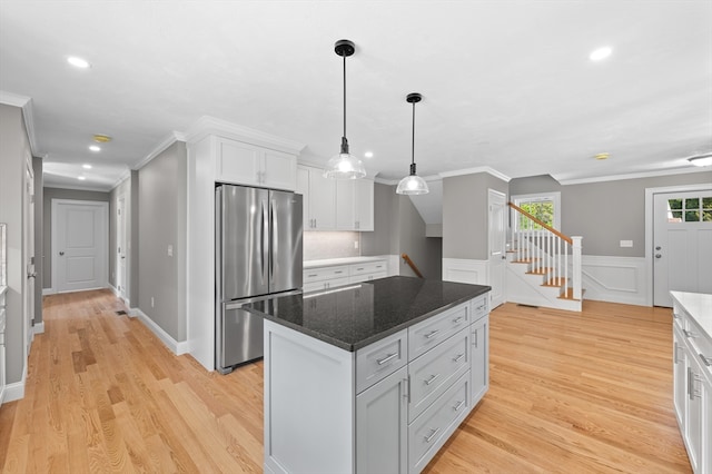 233 W Mountain St, Worcester, MA 01606 - kitchen with freestanding refrigerator, white cabinets, recessed lighting, light wood finished floors, and a kitchen island