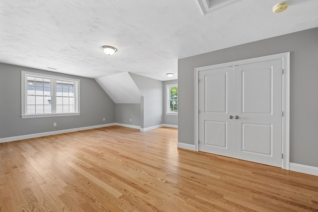 233 W Mountain St, Worcester, MA 01606 - bonus room featuring light wood finished floors, baseboards, a textured ceiling, and vaulted ceiling