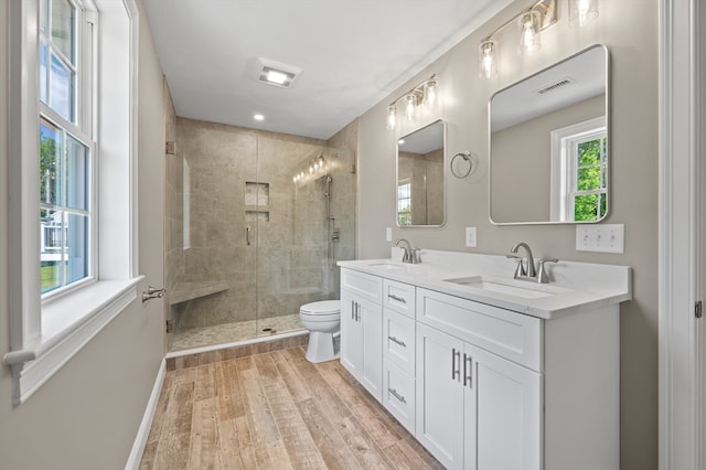233 W Mountain St, Worcester, MA 01606 - bathroom featuring double vanity, wood finished floors, a shower stall, toilet, and baseboards
