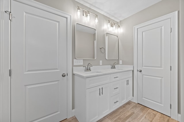 233 W Mountain St, Worcester, MA 01606 - full bath with double vanity, wood finished floors, and baseboards
