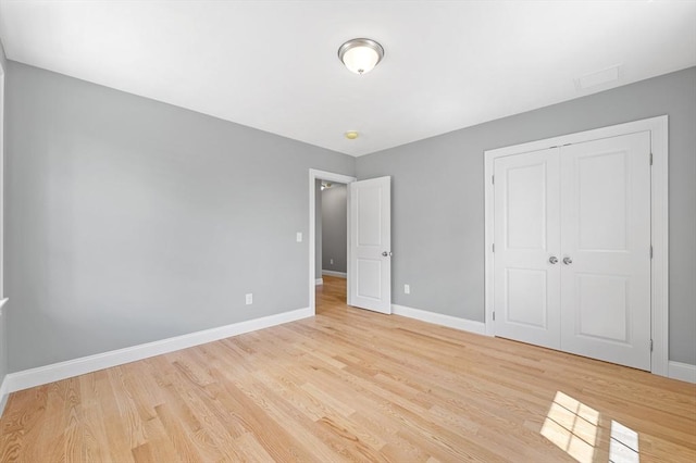 233 W Mountain St, Worcester, MA 01606 - unfurnished bedroom with light wood-style floors, baseboards, and a closet