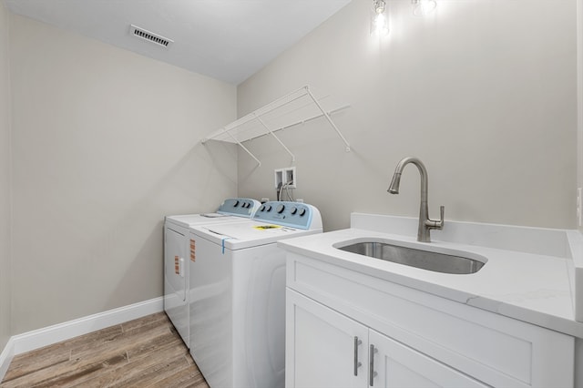 233 W Mountain St, Worcester, MA 01606 - laundry room featuring separate washer and dryer, light wood-style floors, cabinet space, and baseboards