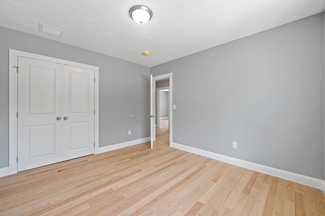 233 W Mountain St, Worcester, MA 01606 - unfurnished bedroom featuring baseboards, light wood-style flooring, and a closet