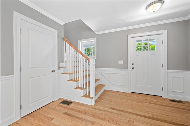 233 W Mountain St, Worcester, MA 01606 - foyer with healthy amount of natural light, light wood-style floors, wainscoting, stairs, and ornamental molding