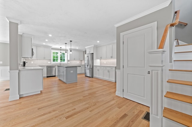 233 W Mountain St, Worcester, MA 01606 - kitchen with stainless steel appliances, a center island, recessed lighting, crown molding, and backsplash