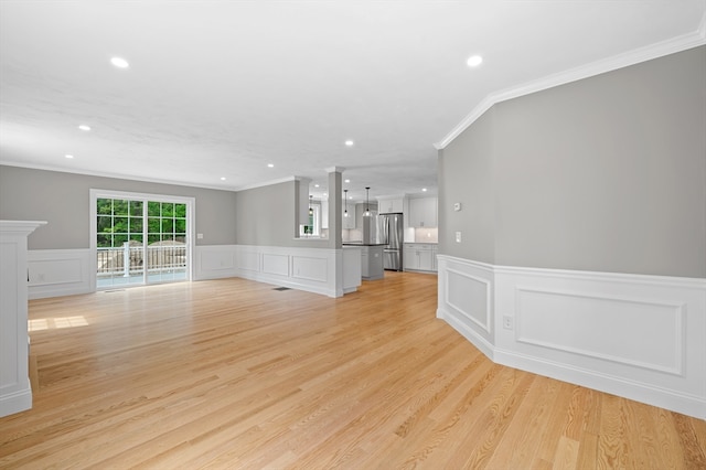 233 W Mountain St, Worcester, MA 01606 - unfurnished living room with ornamental molding, recessed lighting, a decorative wall, wainscoting, and light wood-style floors