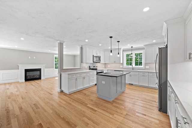 233 W Mountain St, Worcester, MA 01606 - kitchen with appliances with stainless steel finishes, recessed lighting, a center island, backsplash, and light wood finished floors