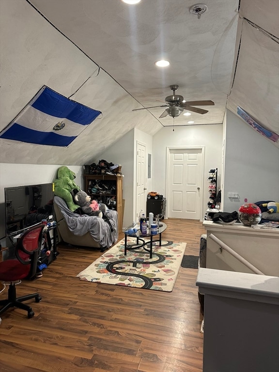 additional living space with ceiling fan, hardwood / wood-style floors, and vaulted ceiling