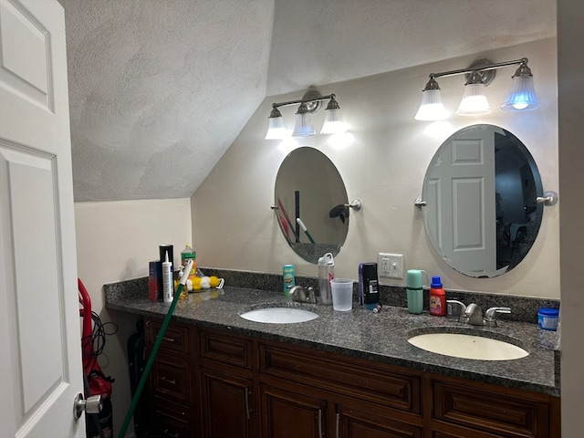 bathroom featuring vanity and lofted ceiling