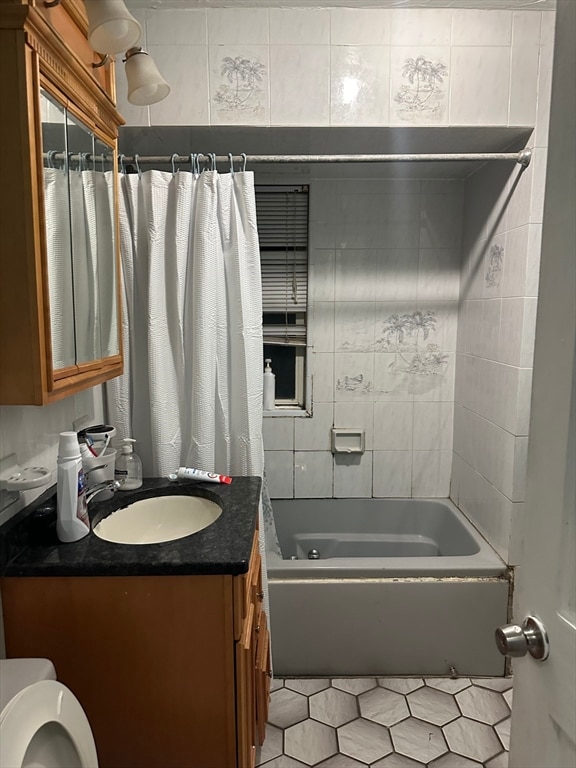 full bathroom with vanity, tile patterned flooring, shower / bathtub combination with curtain, and toilet