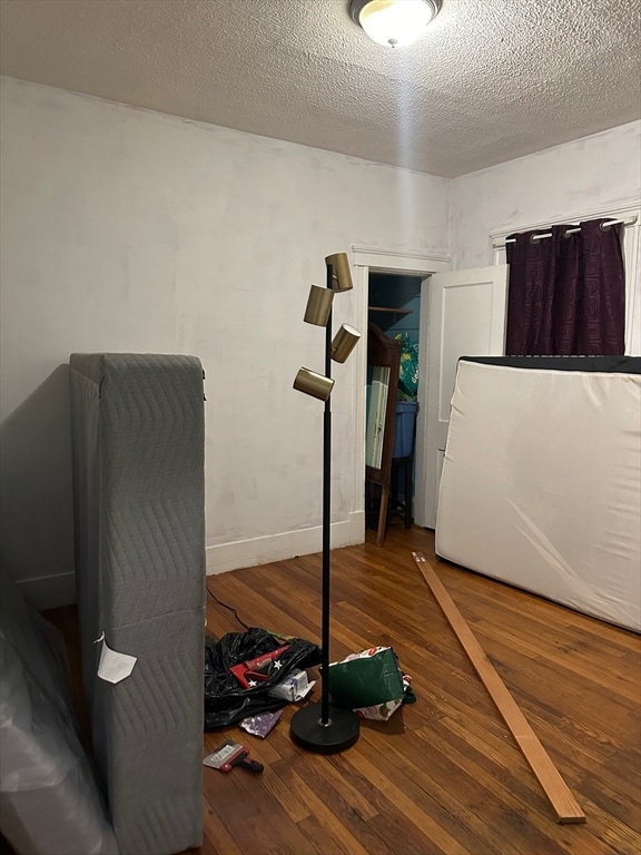 interior space with hardwood / wood-style floors and a textured ceiling