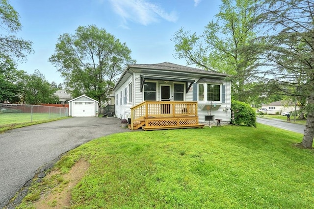 2 Pierce St, Agawam, MA 01030 - view of front of property featuring a garage, an outbuilding, and asphalt driveway