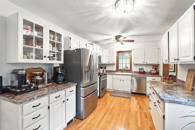 2 Pierce St, Agawam, MA 01030 - kitchen with stainless steel appliances, a textured ceiling, white cabinets, light wood-style flooring, and a ceiling fan