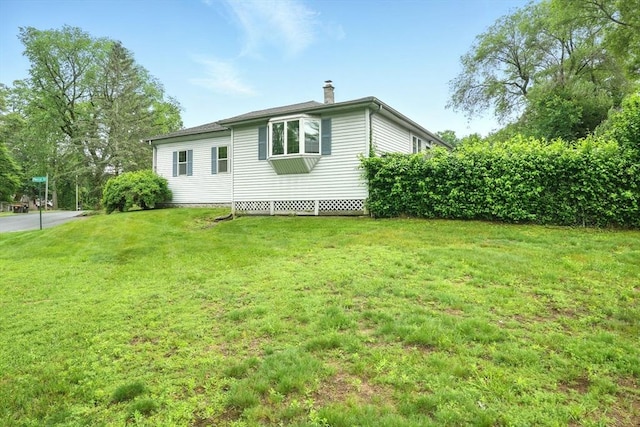 2 Pierce St, Agawam, MA 01030 - view of property exterior featuring a chimney and a lawn