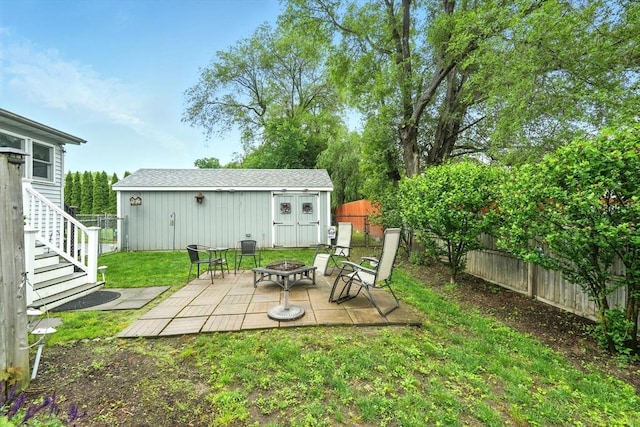 2 Pierce St, Agawam, MA 01030 - fenced backyard with an outdoor fire pit, an outdoor structure, and a patio