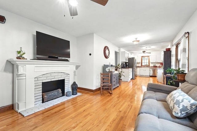 2 Pierce St, Agawam, MA 01030 - living room with ceiling fan, light wood-type flooring, and a fireplace