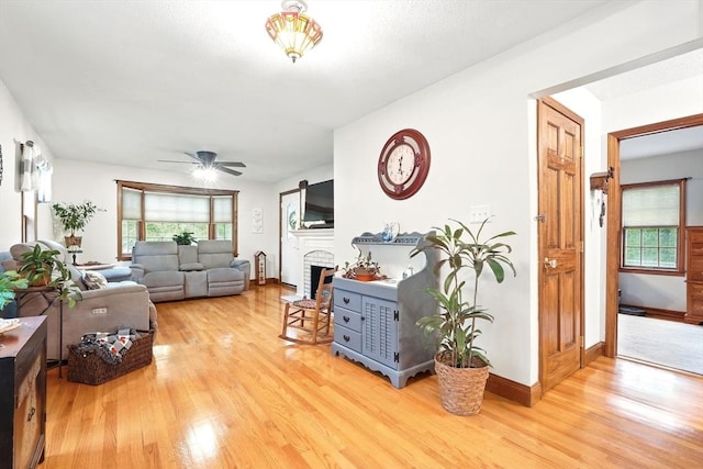 2 Pierce St, Agawam, MA 01030 - living room featuring light wood-type flooring, plenty of natural light, a ceiling fan, and a brick fireplace