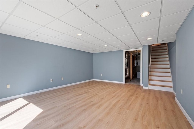 98 Caspian Way Unit 98, Fitchburg, MA 01420 - finished basement with light wood-style floors, stairway, baseboards, and a paneled ceiling