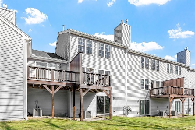 98 Caspian Way Unit 98, Fitchburg, MA 01420 - back of house featuring a wooden deck, a chimney, a yard, and central AC