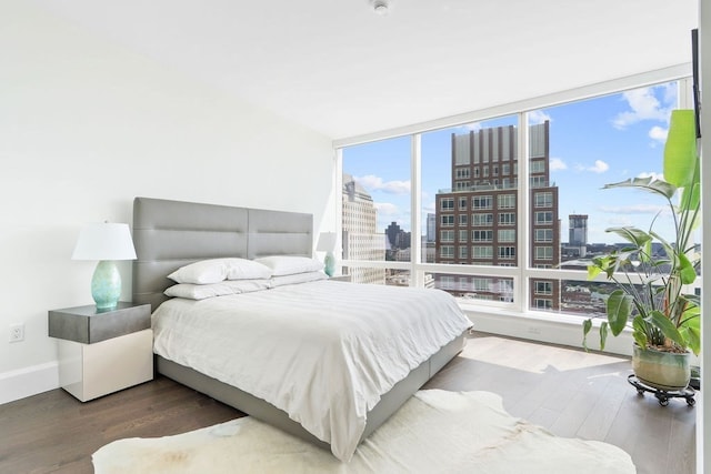 bedroom featuring multiple windows and hardwood / wood-style floors