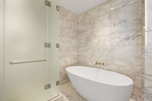 bathroom featuring tile walls and plus walk in shower