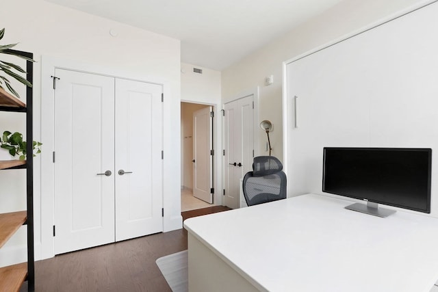 office with dark hardwood / wood-style flooring