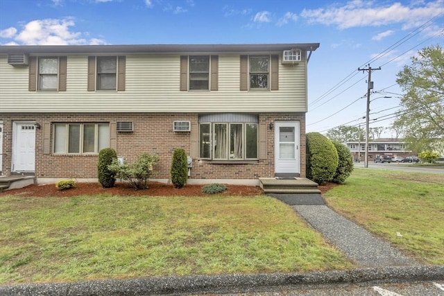 340 Dale St Unit A, Chicopee, MA 01020 - view of front facade with a front yard, brick siding, and an AC wall unit