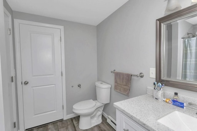 340 Dale St Unit A, Chicopee, MA 01020 - full bathroom featuring toilet, wood finished floors, a baseboard radiator, baseboards, and vanity
