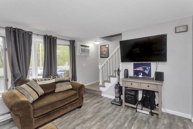 340 Dale St Unit A, Chicopee, MA 01020 - living room featuring stairway, baseboards, a wall unit AC, and wood finished floors