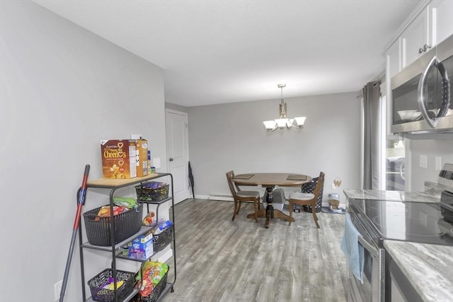 340 Dale St Unit A, Chicopee, MA 01020 - dining space with an inviting chandelier, light wood-type flooring, baseboards, and baseboard heating